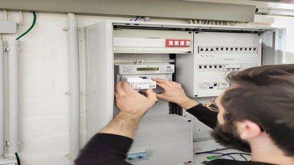 Electrician installs a smart meter